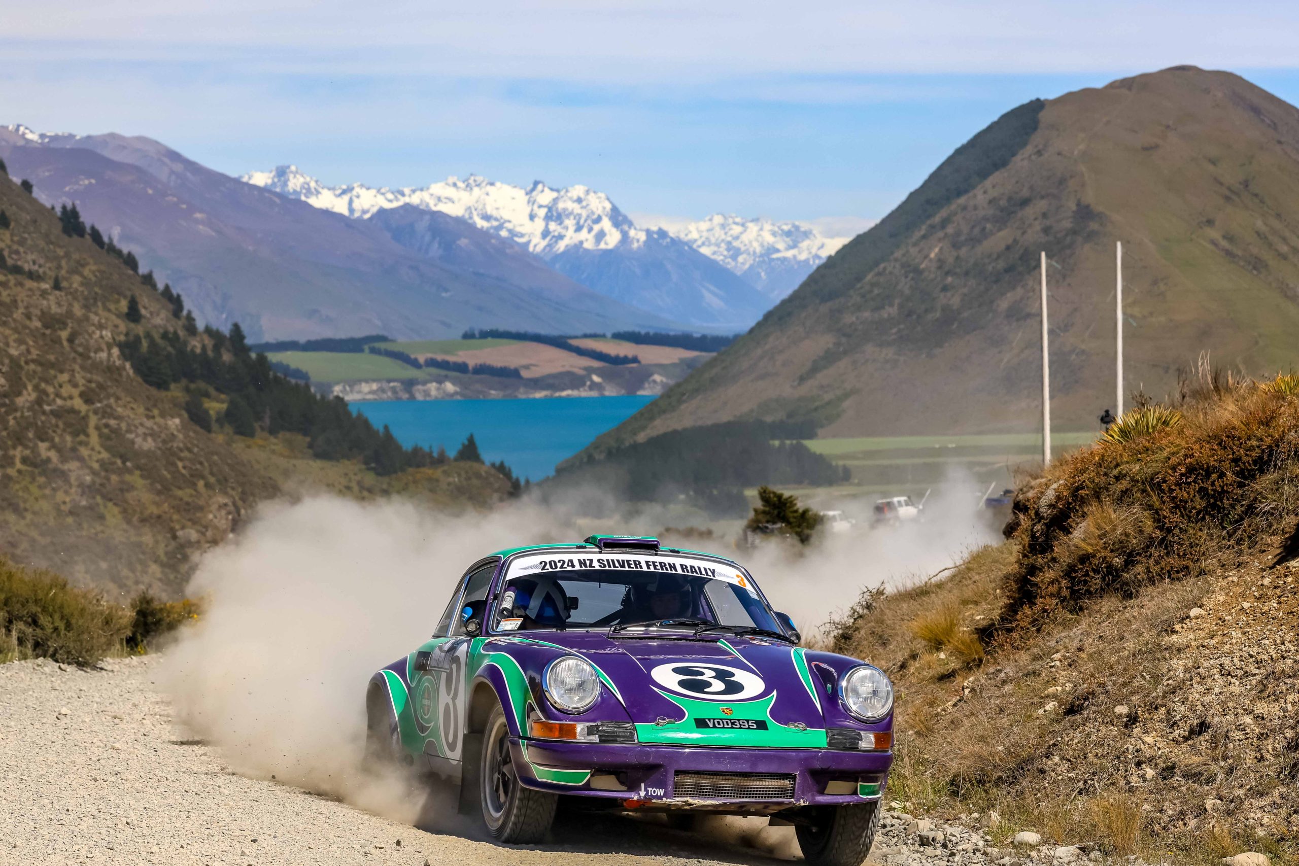 Silver Fern Rally car charging across New Zealand gravel with dramatic scenery