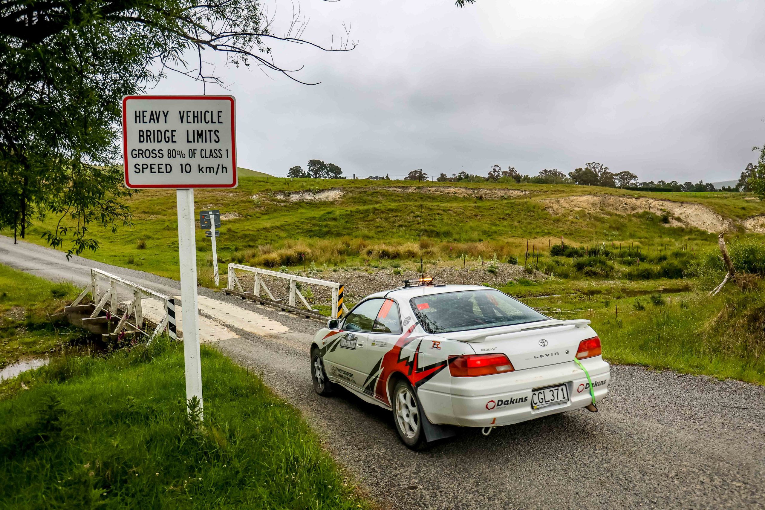 Modern 2WD rally car on gravel stage